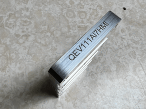 Metal industrial heat sink part with a high-precision laser-engraved serial code