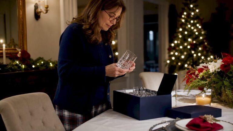 Woman examining custom engraved whiskey glasses