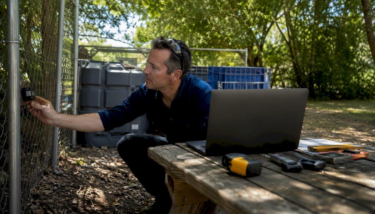 Engineer examining outdoor asset tags