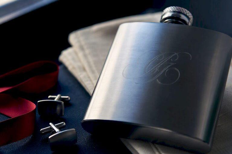 Close-up of engraved flask at wedding preparation
