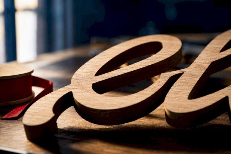 Close-up of connected laser-cut wood lettering