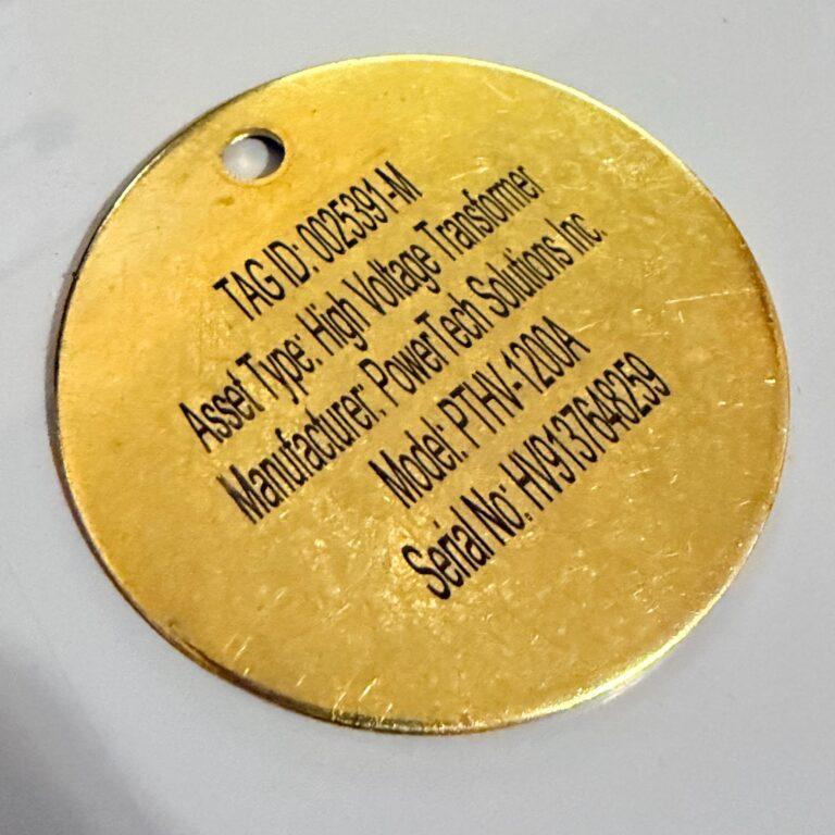 Brass asset tag engraved with tag ID, model and serial number